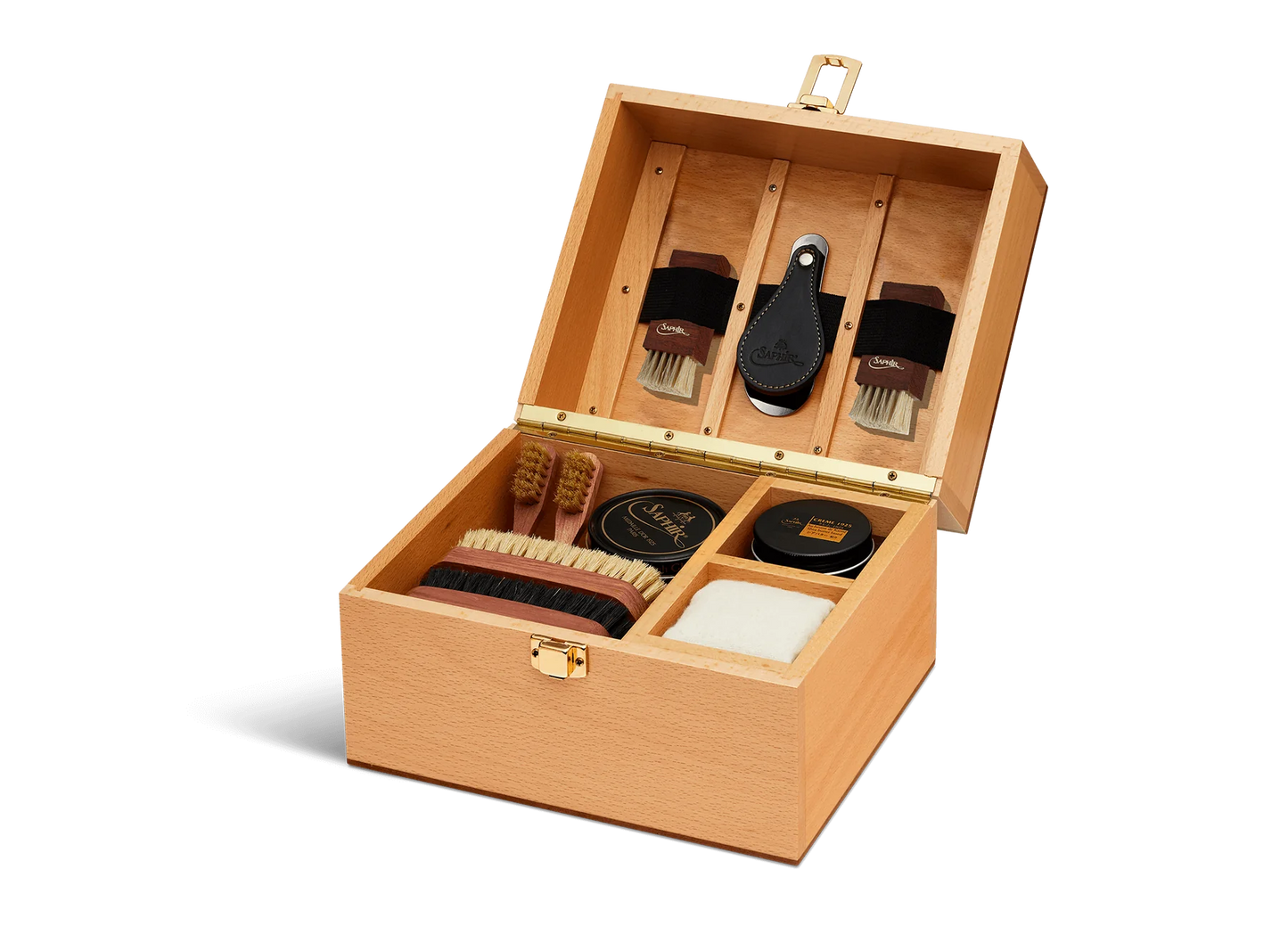 For the leather connoisseur. Presented in a stunning Beechwood box. A wonderful gift or addition to the shoe arsenal. Solid beech frame made in France, with a natural finish and vegetal leather trims. The Groom Deluxe Box contains the following: 2 x 100ml shoe polish tin (1 x black, 1 x dark brown) 1 x renovator cream 2 x Spatula brushes 2 x Shoe polisher brushes 2 x Small spreaders 1 x Polish cloth Size: 37X20X15cm