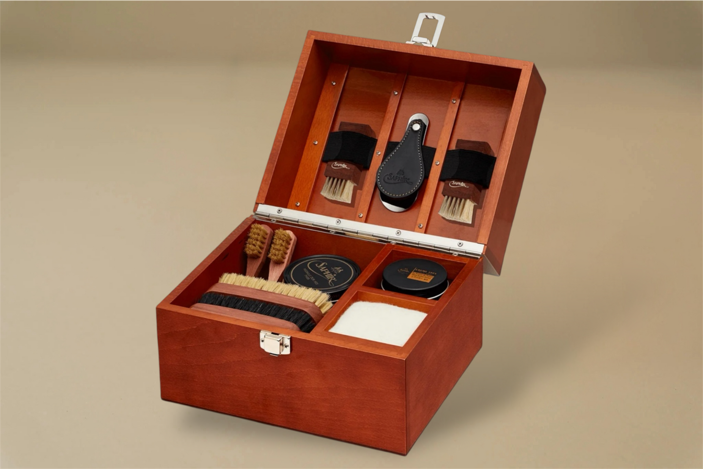 For the leather connoisseur. Presented in a stunning Beechwood box. A wonderful gift or addition to the shoe arsenal. Solid beech frame made in France, with a natural finish and vegetal leather trims. The Groom Deluxe Box contains the following: 2 x 100ml shoe polish tin (1 x black, 1 x dark brown) 1 x renovator cream 2 x Spatula brushes 2 x Shoe polisher brushes 2 x Small spreaders 1 x Polish cloth Size: 37X20X15cm