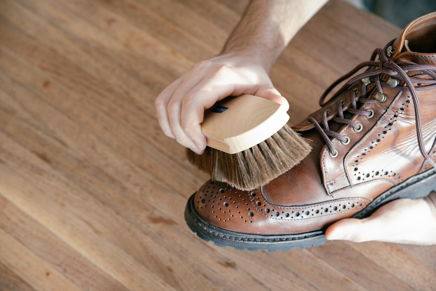 Saphir Beaute De Cuir shine brush shown brushing a pair of allen edmonds long branch cxl boots