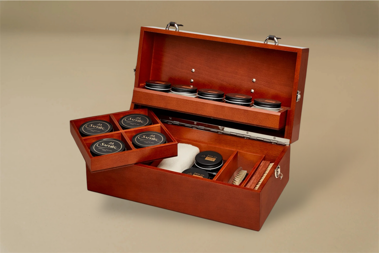 For the leather aficiando. Presented in a stunning Beechwood box. A wonderful gift or addition to the shoe arsenal. Solid beech frame made in France, with a beautiful Mahogany finish and chocolate leather trims.    The Intendant Box contains the following:  Included:  5 x Shoe cream jars- neutral, black, light brown, med.brow and dk. brown 4 x Tins 50ml shoe polish-neutral, black, med.brown, and dk. brown 2 x Shoe polishes brushes 18cm 2 x Small spreaders, 1 cloth, 1 shoe horn  Size : 37 x 20 x 15 cm