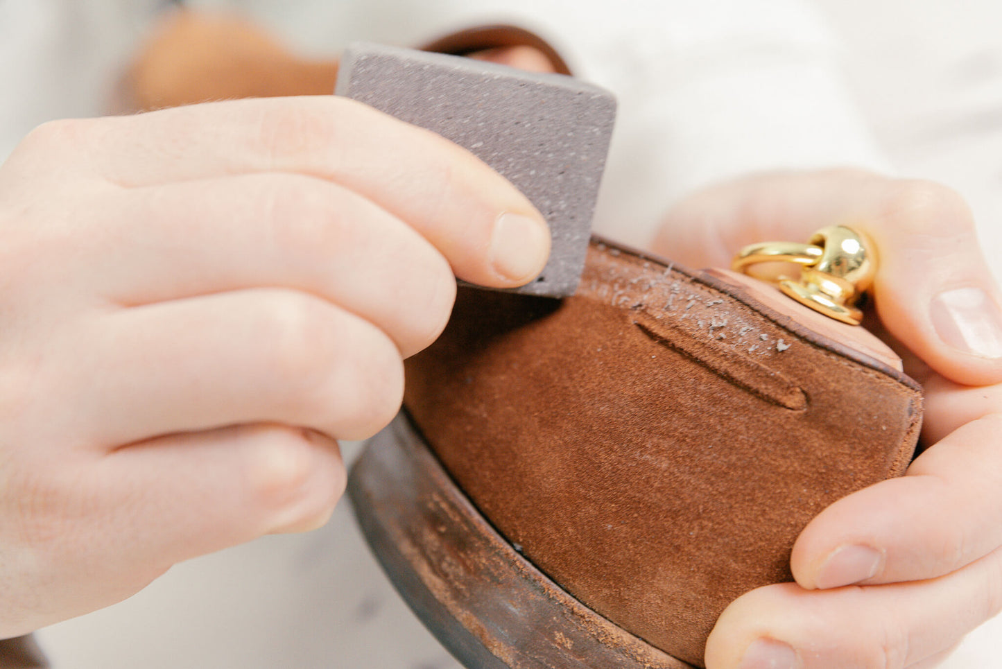 Crockett & Jones polo snuff suede cavendish loafer shown with Saphir crepe brush, omni'nettoyant suede cleaner, suede gommadin brick, and saphir MDO horsehair brush and Saphir Cedar Shoe trees with close up of suede brick being used